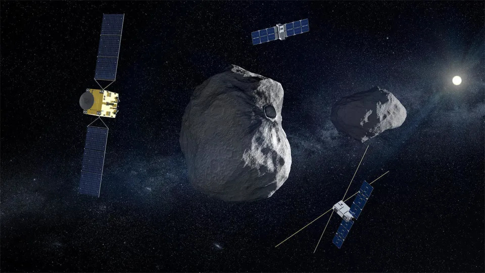 An artist's impression of the European Space Agency's Hera probe (left) and two small sub-satellites that will orbit the asteroid Didymos and its small moon Dimorphos to learn more about how the high-speed impact of NASA's DART probe in September 2022 altered the moonlet's orbit and structure. Both missions are part of an effort to determine how to safely deflect an asteroid on a collision course with Earth. / Credit: ESA