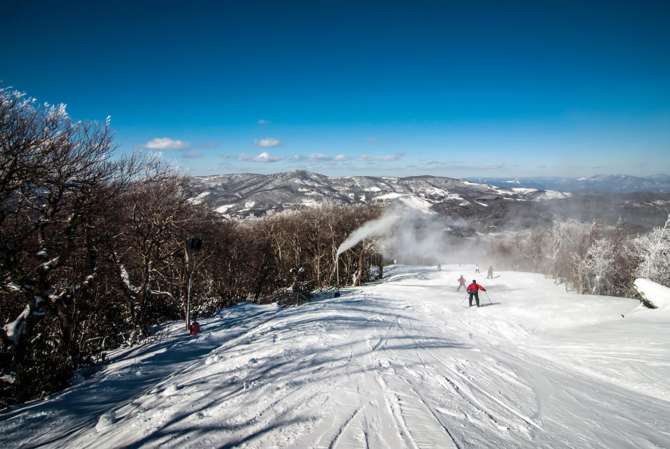 slope at a North Carolina ski resort on a sunny day with skiiers