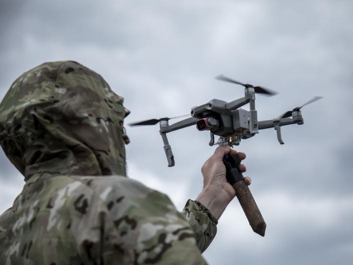 A Ukrainian serviceman attach a 3D version of an explosive as he trains to drop explosives devices from a drone in a secret location in Lviv Oblast, Ukraine.