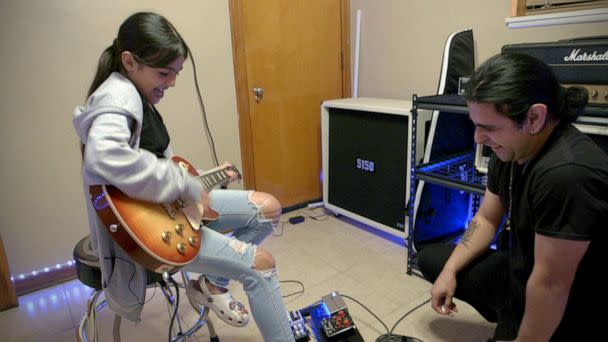 PHOTO: Caitlyne Gonzales rocks on an electric guitar with her instructor on Jan. 10, 2023. (Brian Mezerski/ABC News)