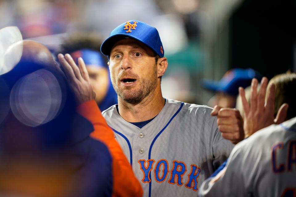 New York Mets starting pitcher Max Scherzer reacts with his teammates after pitching the sixth inning of a baseball game against the Washington Nationals at Nationals Park, Friday, April 8, 2022, in Washington.