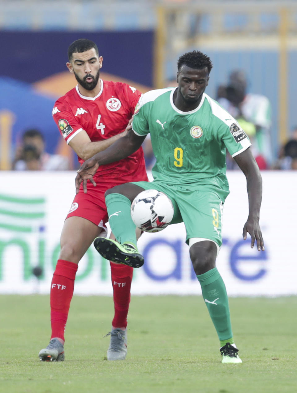 Senegal's Mbaye Hamady Niang controlls the ball in front of Tunisia's Yassine Meriah during the African Cup of Nations semifinal soccer match between Senegal and Tunisia in 30 June stadium in Cairo, Egypt, Sunday, July 14, 2019. (AP Photo/Hassan Ammar)