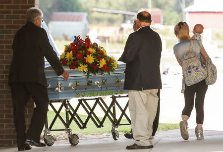 FILE PHOTO: A casket with Jacob Hall -- a 6-year-old South Carolina boy wounded in a schoolyard shooting who died October 1 -- arrives for a service in Townville, South Carolina October 4, 2016. REUTERS/Ken Ruinard/Pool/File Photo