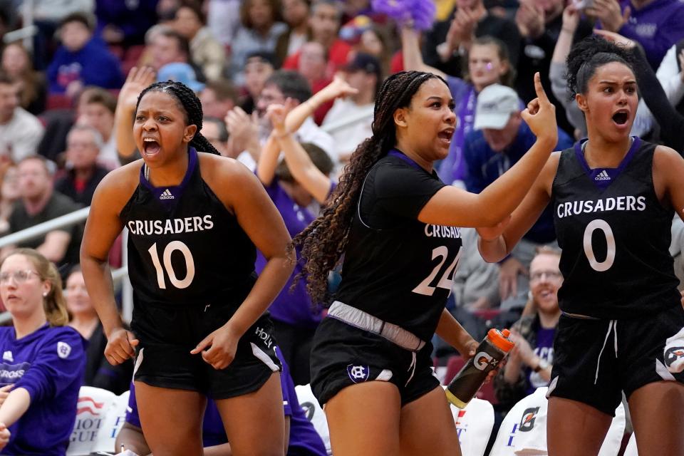 Holy Cross forward Janelle Allen (10), guard Simone Foreman (24), and forward Callie Wright (0) celebrate toward the end of the Crusaders' win in the Patriot League final at Boston University.