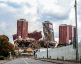 <p>The red road flats in Glasgow begin to crumble to the ground in a planned explosion. (Lesley Smith)</p>