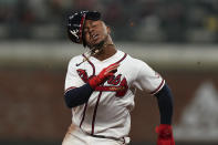 Braves Ozzie Albies loses his helmet as he runs to score on a single by Austin Riley in the eighth inning in Game 2 of baseball's National League Championship Series Sunday, Oct. 17, 2021, in Atlanta. (AP Photo/Brynn Anderson)