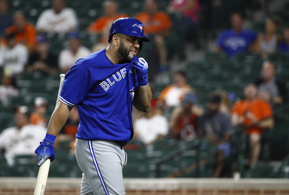 Toronto Blue Jays' Kendrys Morales walks off the field after striking out swinging in the eighth inning of a baseball game against the Baltimore Orioles, Monday, Aug. 27, 2018, in Baltimore. (AP Photo/Patrick Semansky)