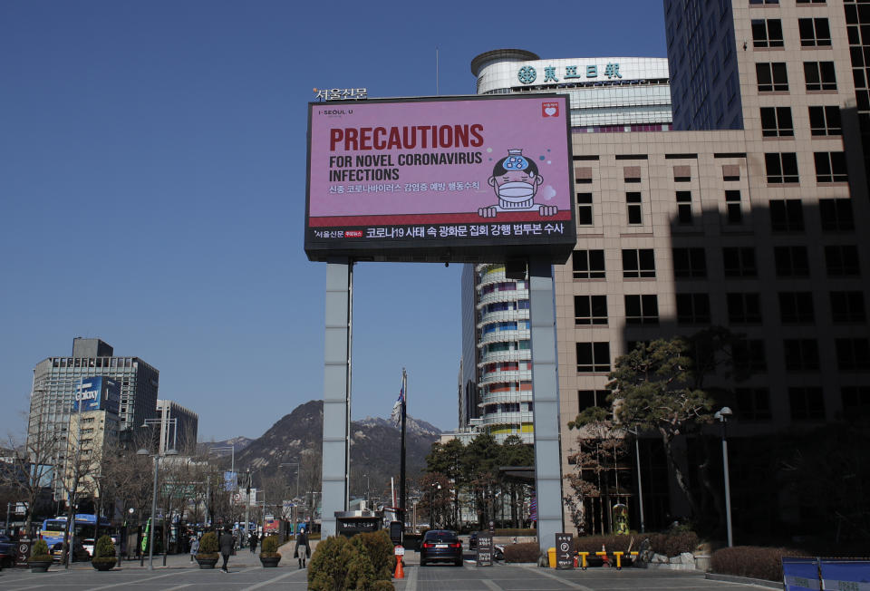 A huge screen displays precautions against the COVID-19 is seen in downtown Seoul, South Korea, Sunday, Feb. 23, 2020. South Korea and China both reported a rise in new virus cases on Sunday, as the South Korean prime minister warned that the fast-spreading outbreak linked to a local church and a hospital in the country's southeast had entered a "more grave stage." (AP Photo/Lee Jin-man)