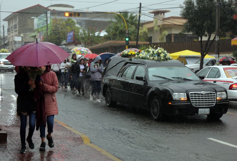 People attend the funeral of several of the victims killed by shooters at a slot-machine arcade in the central Mexican state of Michoacan, in Uruapan