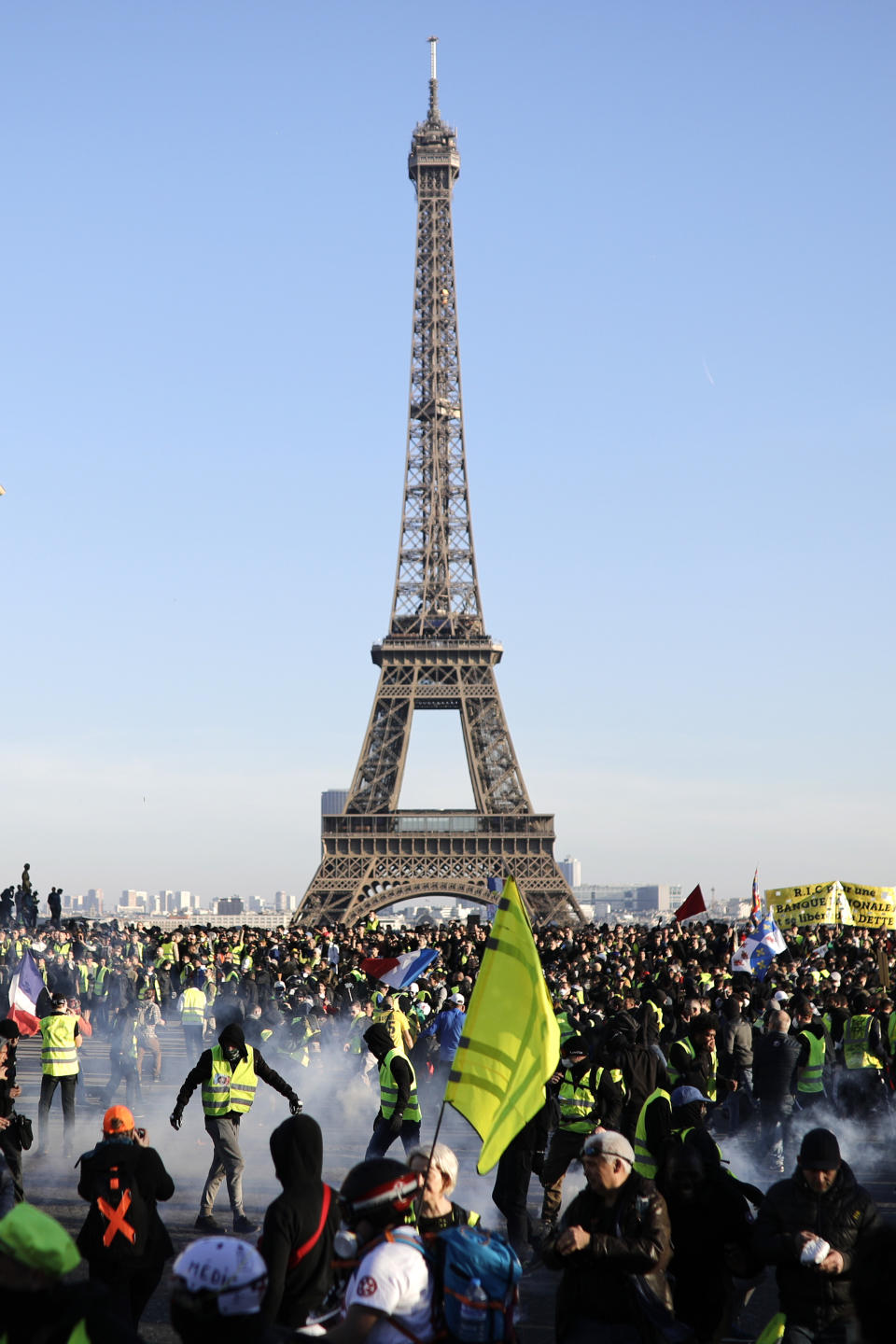 Yellow vest protesters gather at the Trocadero plaza as they demonstrate in the streets of Paris, France, Saturday, Feb. 23, 2019. French yellow vest protest organizers are trying to tamp down violence and anti-Semitism in the movement's ranks as they launch a 15th straight weekend of demonstrations. (AP Photo/Kamil Zihnioglu)