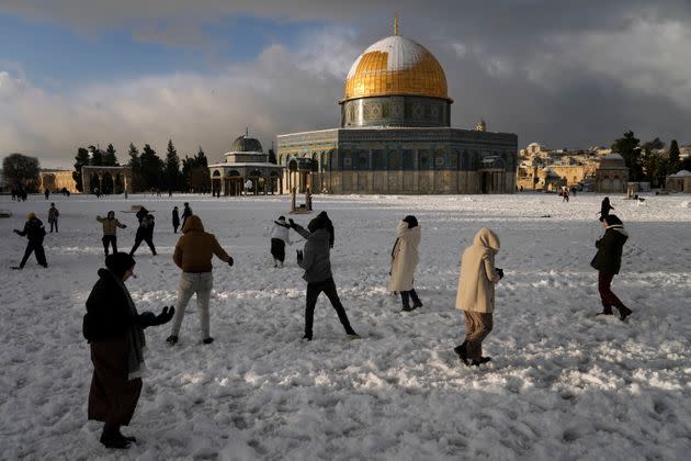 Palestinians enjoy the snow next to the Dome of the Rock Mosque in the Al Aqsa Mosque compound in Jerusalem Old city on Thursday. A rare snowfall hit parts of Israel and the West Bank, closing schools and businesses.  (Photo: Mahmoud Illean / AP)