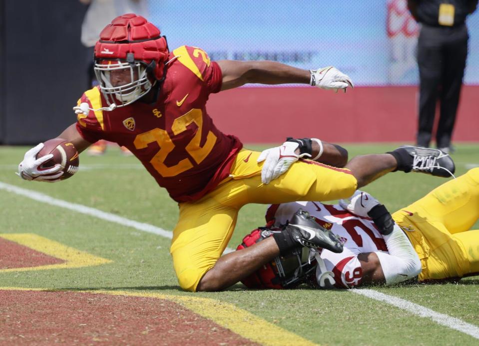 USC running back A'Marion Peterson scores a touchdown over linebacker Elijah Newby.