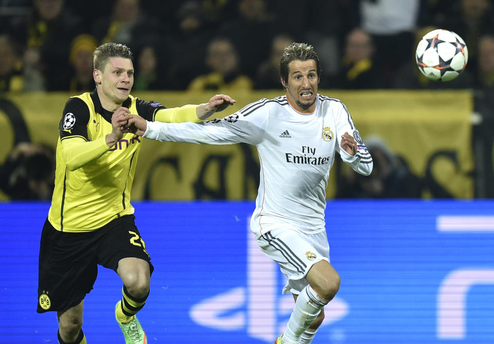 Real's Fabio Coentrao, right, fights for the ball with Dortmund's Lukasz Piszczek during the Champions League quarterfinal second leg soccer match between Borussia Dortmund and Real Madrid in the Signal Iduna stadium in Dortmund, Germany, Tuesday, April 8, 2014. (AP Photo/Martin Meissner)