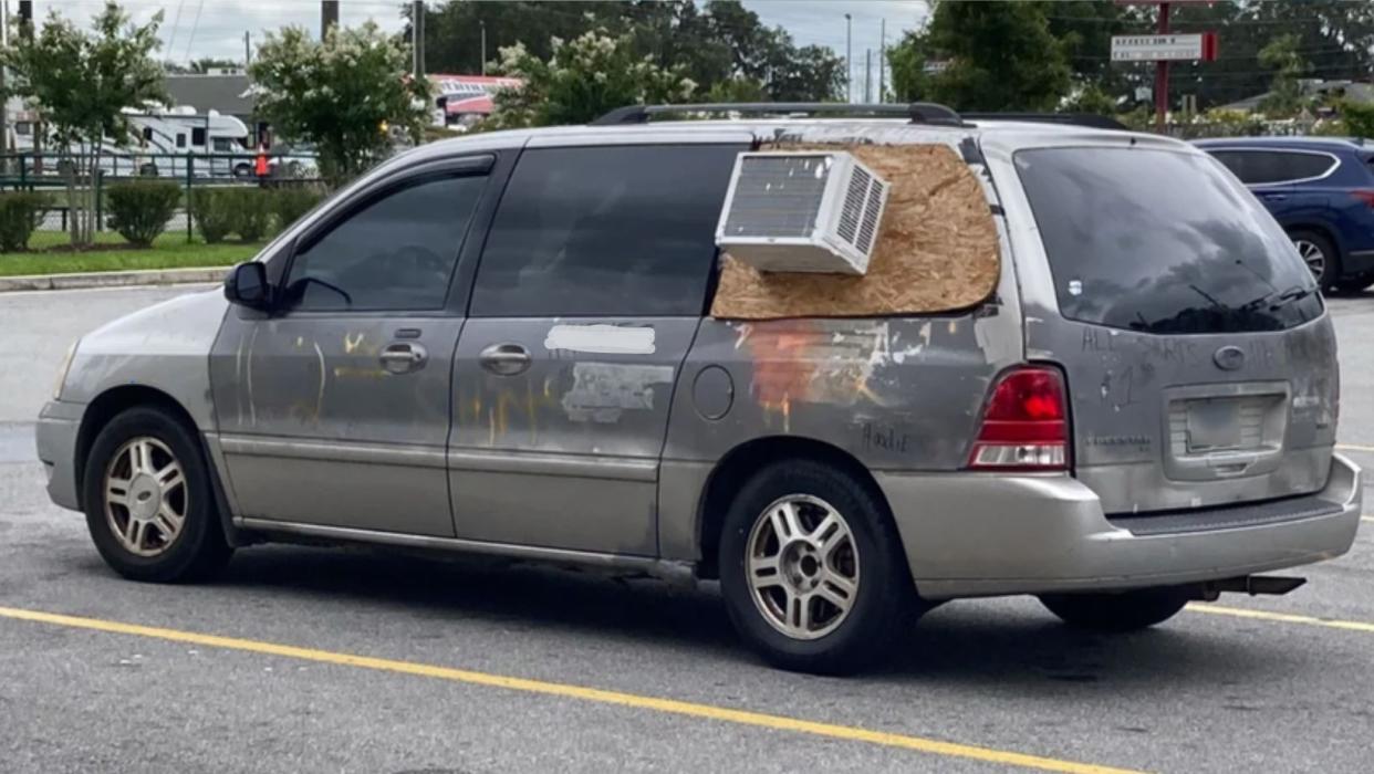 Van with an Air conditioner mounted to the rear window