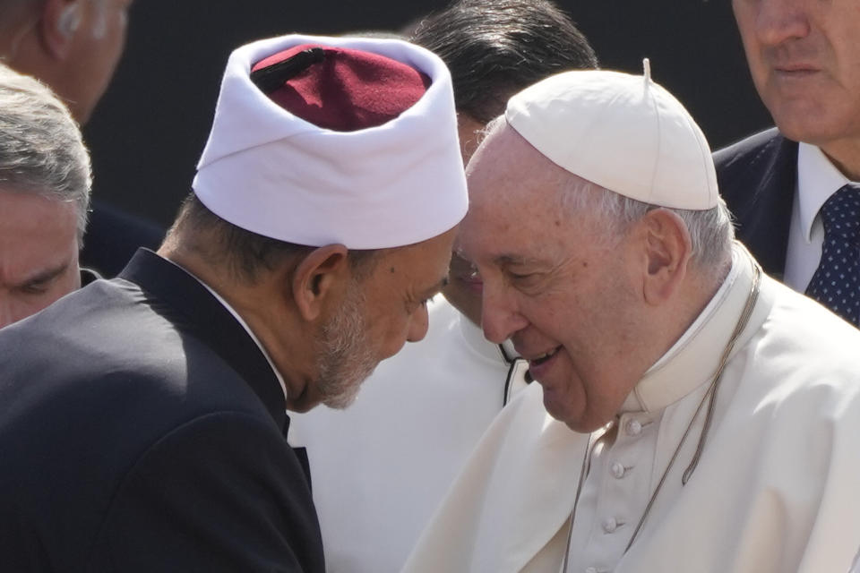 Pope Francis is welcomed by Ahmed El-Tayeb, Grand Imam of al-Azhar, as he arrives to attend the closing session of the "Bahrain Forum for Dialogue: East and west for Human Coexistence", at the Al-Fida square at the Sakhir Royal palace, Bahrain, Friday, Nov. 4, 2022. Pope Francis is making the November 3-6 visit to participate in a government-sponsored conference on East-West dialogue and to minister to Bahrain's tiny Catholic community, part of his effort to pursue dialogue with the Muslim world. (AP Photo/Alessandra Tarantino)