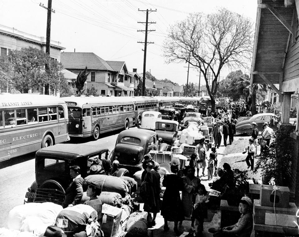 This 1942 photo shows Japanese Americans leaving their homes in Los Angeles, California, to be sent to detention centers. The sidewalks are piled high with personal possessions.