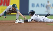 New York Yankees' Josh Donaldson (28) beats the tag of Oakland Athletics second baseman Nick Allen on a double during the first inning of a baseball game Tuesday, June 28, 2022, in New York. (AP Photo/Noah K. Murray)