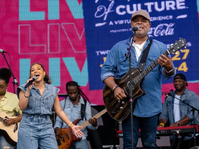 <p>Josh Brasted/Getty</p> Adrienne Bailon and Israel Houghton perform together in 2021