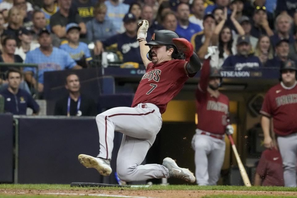 Arizona Diamondbacks' Corbin Carroll scores on a hit by Ketel Marte during the sixth inning of a Game 2 of their National League wildcard baseball series against the Milwaukee Brewers Wednesday, Oct. 4, 2023, in Milwaukee. (AP Photo/Morry Gash)
