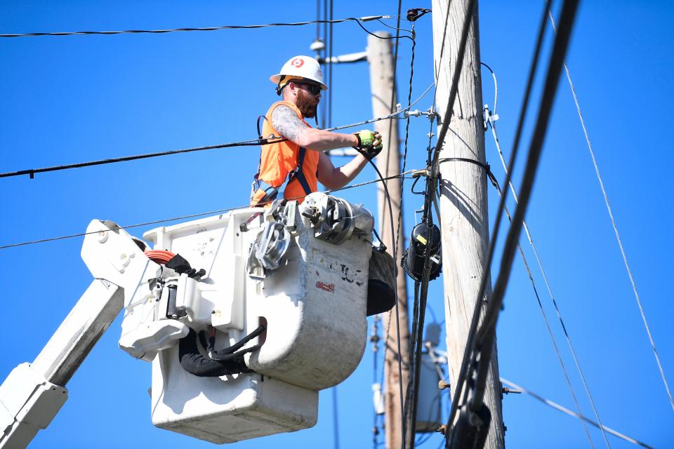 In this file photo from March 2020, Jeffrey Brown works on fiber-optic cables that will provide broadband internet outside of Carson-Newman University in Jefferson City, Tenn., on March 25, 2020.