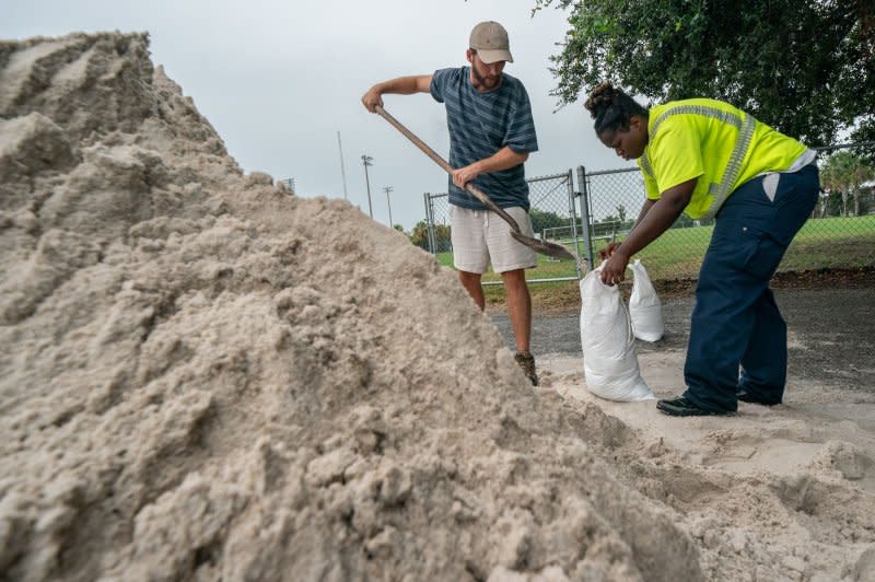 A resident is assisted by a city worker with filling sandbags in preparation for the arrival of Hurricane Idalia in Mount Pleasant, S.C., on August 30. File Photo by Richard Ellis/UPI