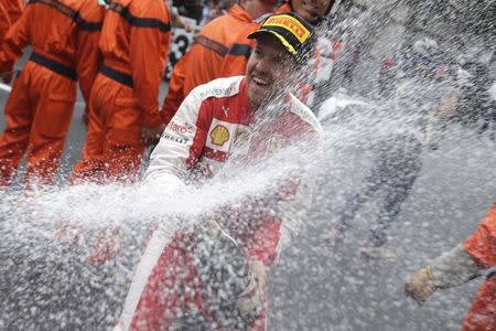 Ferrari Formula One driver Sebastian Vettel of Germany sprays champagne after getting the second place in the Monaco F1 Grand Prix May 24, 2015. REUTERS/Max Rossi