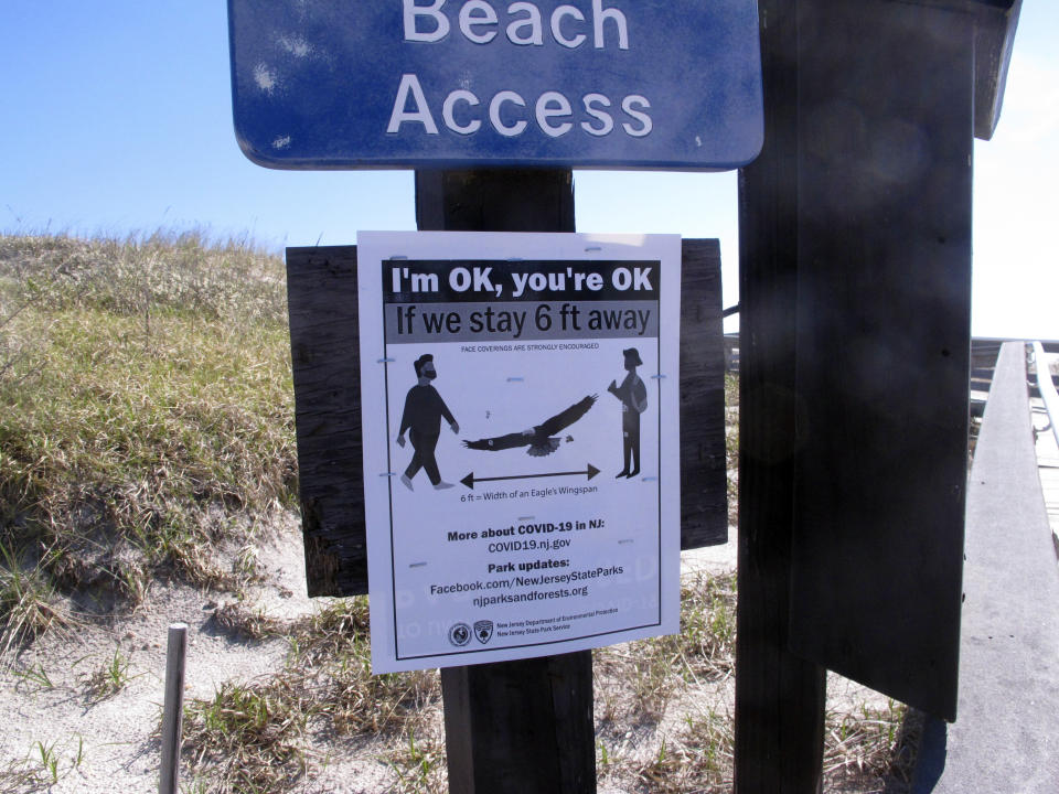 A sign at the entrance to Island Beach State Park on May 2, 2020, in New Jersey, warns beachgoers to separate themselves by at least six feet on the day New Jersey's state parks reopened after a closure brought on by the coronavirus outbreak. On March 11, 2024, an independent report examining New Jersey's response to the pandemic said the state and nation were unprepared for it, adding the state is still underprepared for the next crisis. (AP Photo/Wayne Parry)