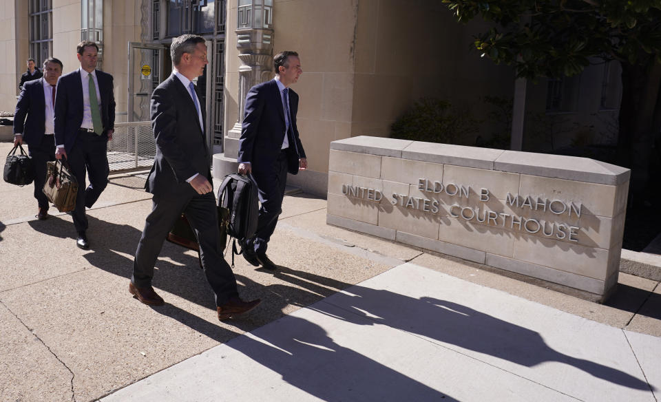 Lawyers for the Boeing Company walk from the federal court building after the arraignment hearing of Boeing in Fort Worth, Texas, Thursday, Jan. 26, 2023. Boeing representatives and relatives of some of the passengers killed in two crashes of Boeing 737 Max jets met face-to-face in a Texas courtroom Thursday, where the aerospace giant was arraigned on a criminal charge that it thought it had settled two years ago. Boeing pleaded not guilty to the charge. (AP Photo/LM Otero)