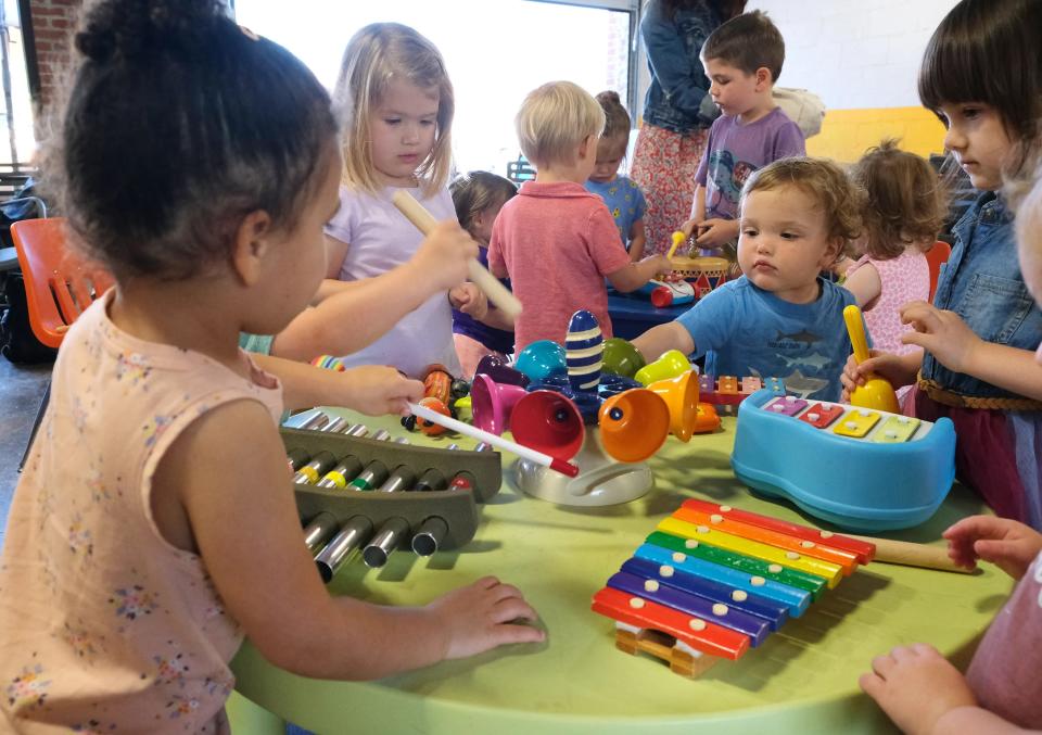 Kids play with instruments during Music Adventure at Swamp Rabbit Cafe and Grocery. 