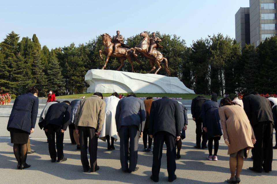 People pay tribute to the statues of late North Korean leaders, Kim Il Sung and Kim Jong Il in the celebration of 110th birth anniversary of state founder Kim Il Sung, in Pyongyang, North Korea on Friday, April 15, 2022. (AP Photo/Jon Chol Jin)