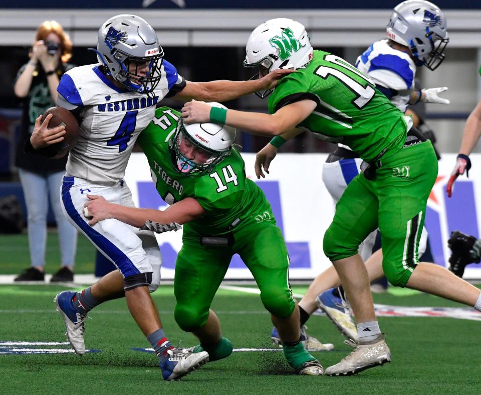 Westbrook running back Cedric Ware is tackled by May linebacker Blake Harrell (14) and defensive back Luke McKenzie during last year's Class 1A Division I championship game in Arlington. Westbrook won 72-66 for its first state title in its first state title game appearance.
