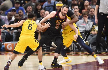 Apr 18, 2018; Cleveland, OH, USA; Cleveland Cavaliers center Kevin Love (0) tries to drive through Indiana Pacers guard Cory Joseph (6) and forward Trevor Booker (20) during the second half in game two of the first round of the 2018 NBA Playoffs at Quicken Loans Arena. Mandatory Credit: Ken Blaze-USA TODAY Sports