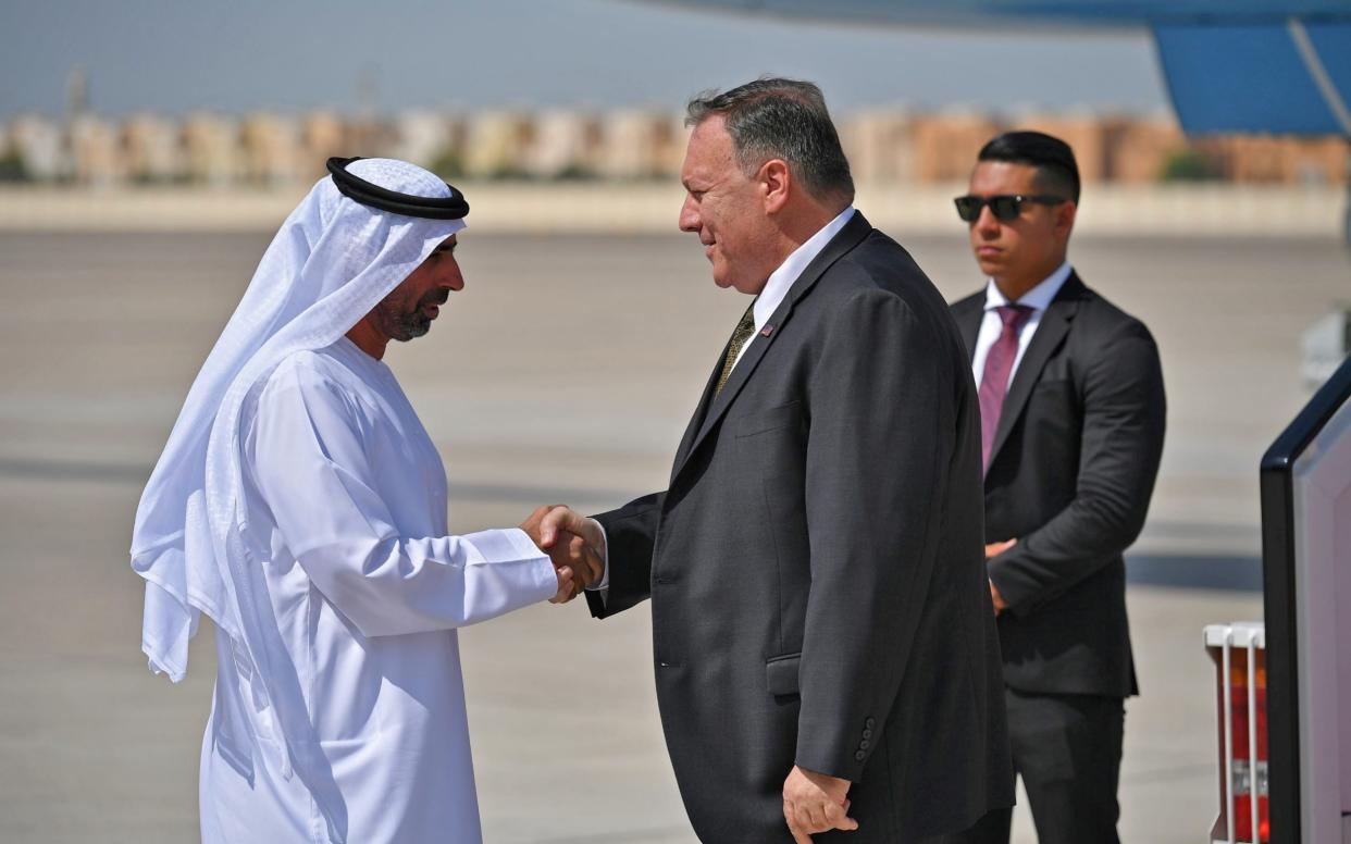 U.S. Secretary of State Mike Pompeo (C) shakes hands with an unidentified UAE official upon his arrival at al-Bateen Air Base in Abu Dhabi - Reuters