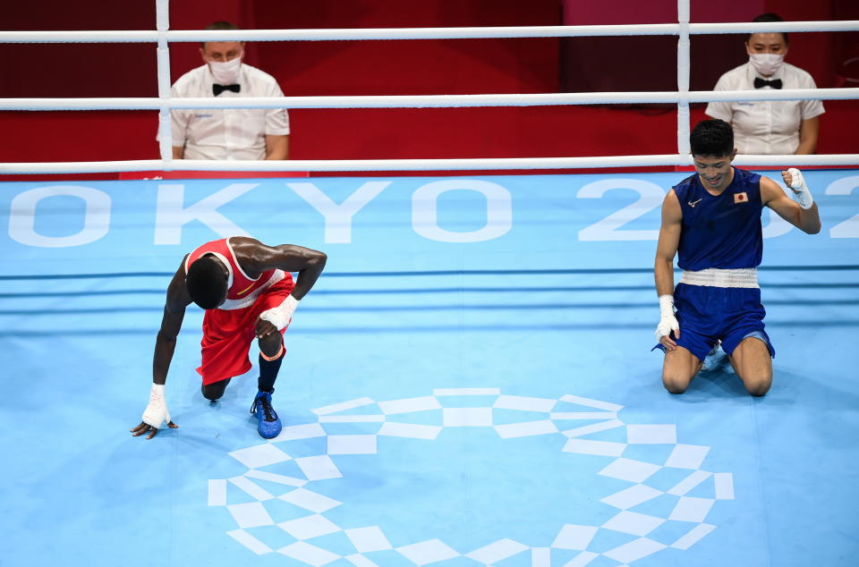 <p>Ryomei Tanaka of Japan, right, after being declared victorious over Yuberjen Herney Martinez Rivas of Colombia during their men's flyweight quarter-final bout at the Kokugikan Arena during the 2020 Tokyo Summer Olympic Games in Tokyo, Japan. (Photo By Stephen McCarthy/Sportsfile via Getty Images)</p> 