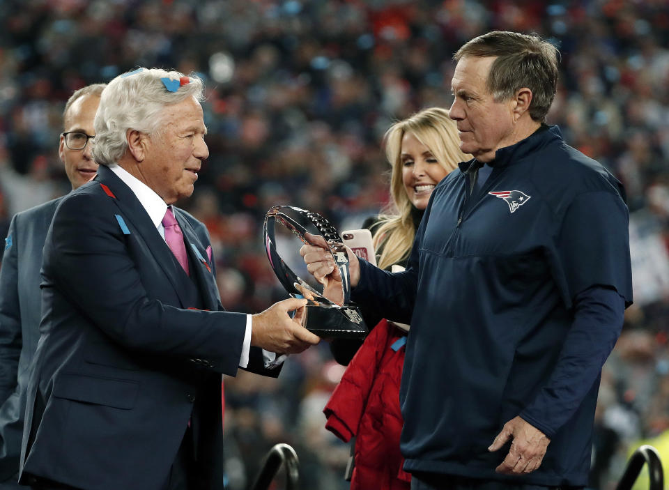 New England Patriots owner Robert Kraft, left, hands the AFC championship trophy to head coach Bill Belichick. (AP)