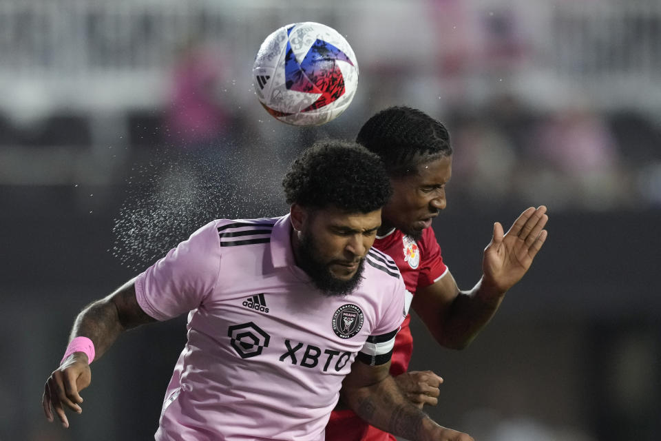 Inter Miami defender DeAndre Yedlin, left, and New York Red Bulls defender Kyle Duncan vie for a head ball during the first half of an MLS soccer match Wednesday, May 31, 2023, in Fort Lauderdale, Fla. (AP Photo/Rebecca Blackwell)