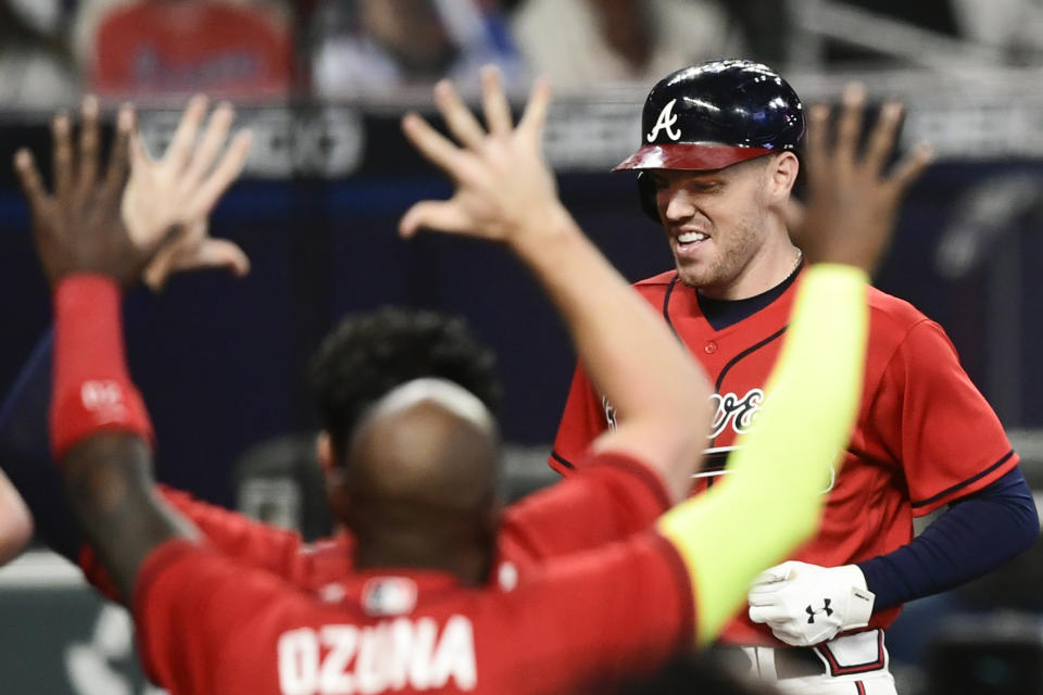 Atlanta Braves' Freddie Freeman crosses home plate to score on a winning two-run home during the 11th inning of a baseball game against the Boston Red Sox, Friday, Sept. 25, 2020, in Atlanta. (AP Photo/John Amis)