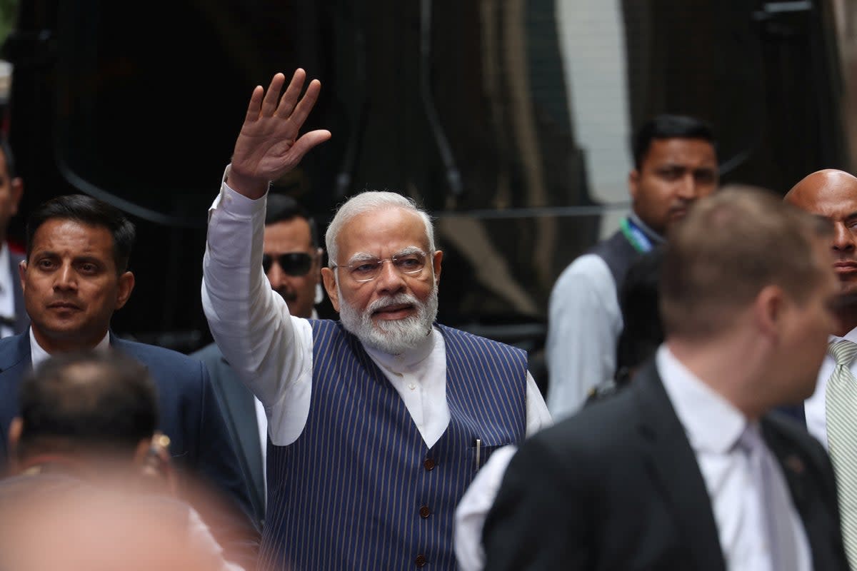 Narendra Modi waves to supporters as he arrives at the Lotte hotel in New York City on 20 June (REUTERS)