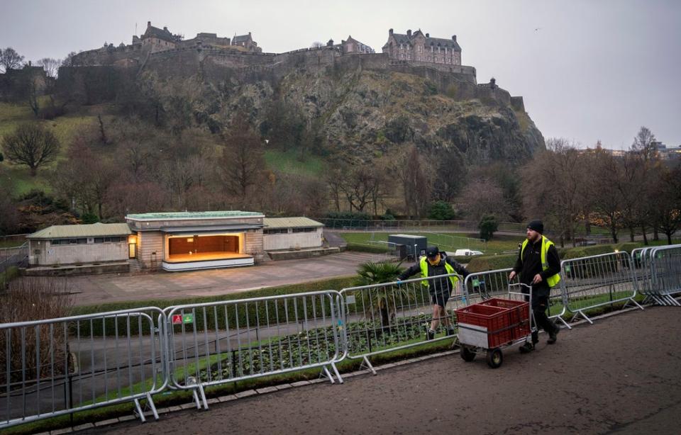 Event staff dismantle some of Edinburgh’s Hogmanay preparations in Princes Street Gardens as this year's public New Year celebrations were cancelled (PA)