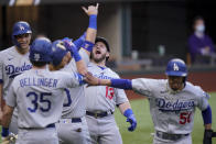 Los Angeles Dodgers' Max Muncy (13) celebrates his grand slam home run during the first inning in Game 3 of a baseball National League Championship Series against the Atlanta Braves Wednesday, Oct. 14, 2020, in Arlington, Texas. (AP Photo/Eric Gay)