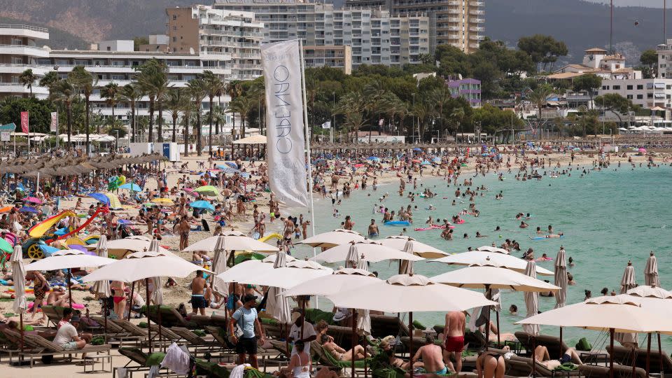 Locals have been protesting to reclaim space from visitor in the Spanish destinations of Mallorca and the Canary Islands. Here, tourists are seen on the beach in Magaluf, Mallorca. - Andrey Rudakov/Bloomberg/Getty Images