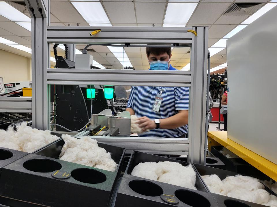 A worker at the USDA Classing Office in Bartlett sorts through cotton samples to grade the fiber qualities on on Tuesday, July 26, 2022.