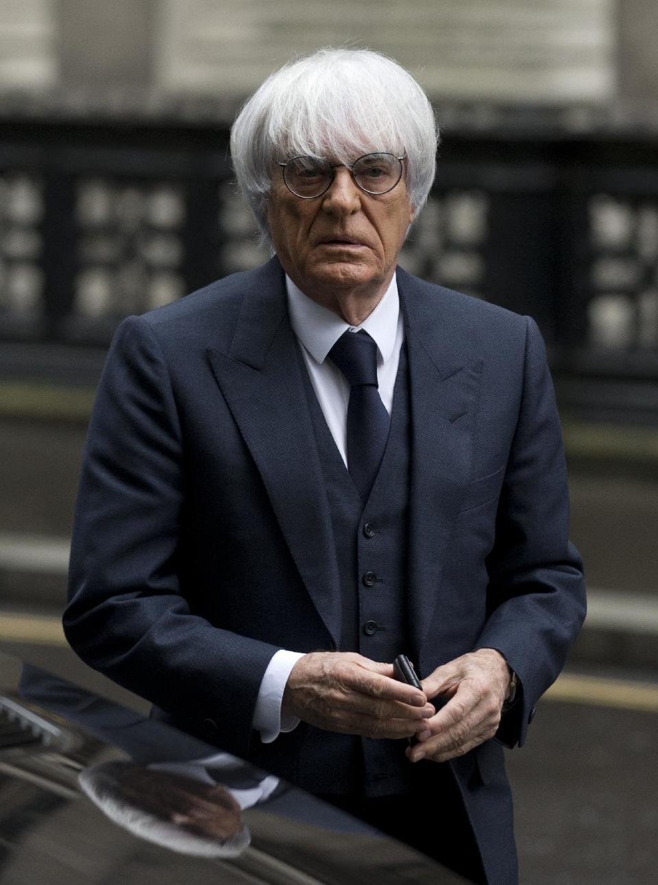 FILE - In this Nov. 11, 2013 file picture President and CEO of Formula One Management Bernie Ecclestone arrives for his case at the High Court in London. A German court says Formula One boss Bernie Ecclestone will go on trial on bribery charges. The Munich state court said Thursday Jan. 16, 2014 that it has decided to send to trial the indictment against the 83-year-old Ecclestone. He faces charges of bribery and incitement to breach of trust connected to the alleged payment of a US $45 million bribe to a German banker. Proceedings are currently expected to start at the end of April. The banker, Gerhard Gribkowsky, already has been convicted of taking the payment from Ecclestone in connection with the sale of a stake in F1. Ecclestone has insisted that he did "nothing illegal." (AP Photo/Matt Dunham. File)