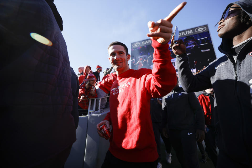 Georgia quarterback Stetson Bennett, center, walks into the stadium during a ceremony celebrating the Bulldog's second consecutive NCAA college football national championship, Saturday, Jan. 14, 2023, in Athens, Ga. (AP Photo/Alex Slitz)