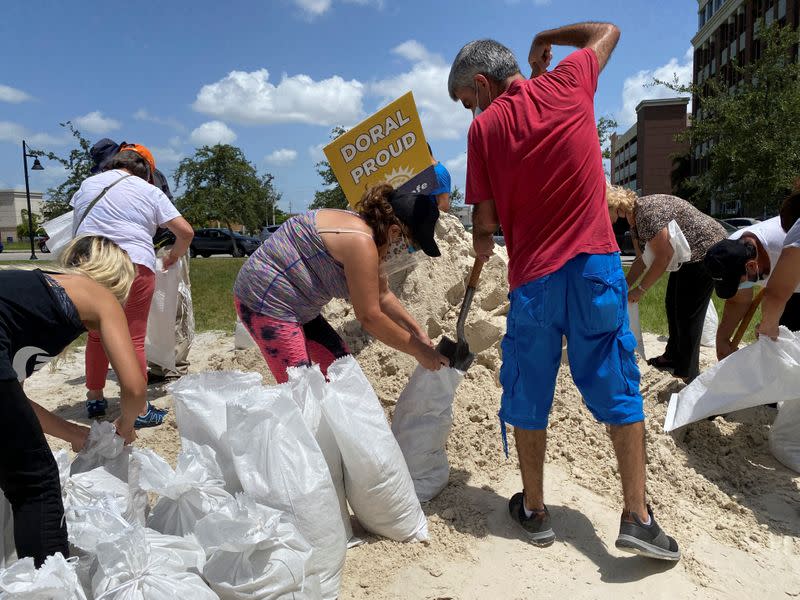 Residents fill and collect sand bags before the expected arrival of Hurricane Isaias in Doral