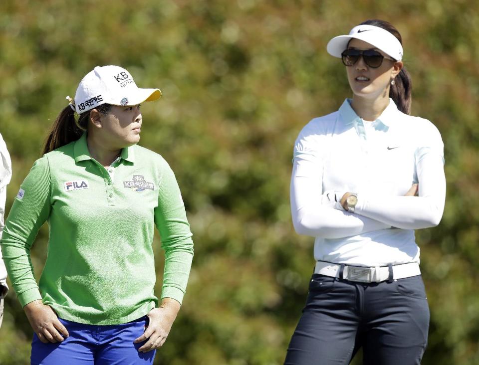 Inbee Park, left, of South Korea, and Michelle Wie wait to tee off on the 11th hole during the first round of the North Texas LPGA Shootout golf tournament at the Las Colinas Country Club in Irving, Texas, Thursday, May 1, 2014. (AP Photo/LM Otero)