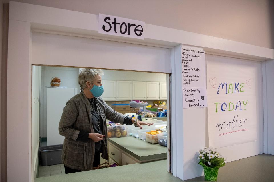 Amanda Pace Kollar, Operation Director of the Code Purple shelter at Trinity United Methodist Church in West Asheville, explains the items available at their shelter's free store January 13, 2022.