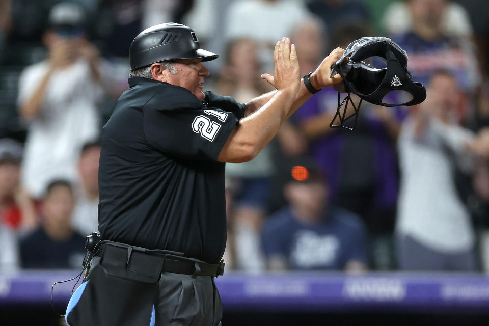 DENVER, COLORADO - JUNE 22: Home plate umpire Hunter Wendelstead #21 calls Kyle Finnegan #67 of the Washington Nationals for a pitch time clock violation, awarding a walk-off win for the Colorado Rockies in the top of the ninth inning at Coors Field on June 22, 2024 in Denver, Colorado. (Photo by Matthew Stockman/Getty Images)