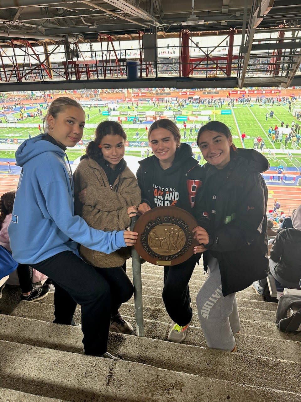 Victorious (but cold) Hasbrouck Heights 4-x-400 team poses with their Penn Relays plaque.
(Photo: Courtesy Hasbrouck Heights track and field)