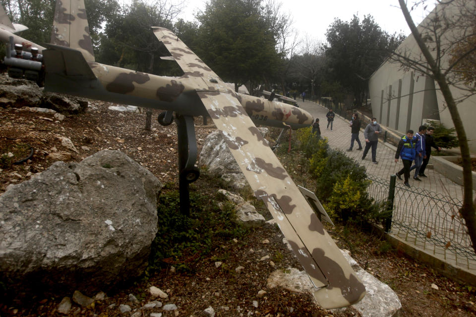 FILE - People look at a replica drone in a war museum operated by Hezbollah in Mlita Village, southern Lebanon, Feb. 19, 2022. Forty years since it was founded, Lebanon's Hezbollah has transformed from a ragtag organization to the largest and most heavily armed militant group in the Middle East. (AP Photo/Mohammed Zaatari, File)